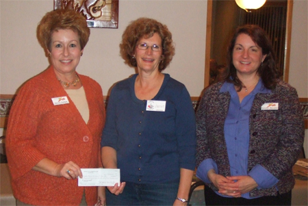 Janet Iansiti presented a check with proceeds from Horsepower at the Zoo to Sherrie Graham and Jennifer Horvatin.
