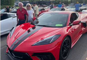 Tom and Chris Wieczorek next to their 2020 Corvette.  Line up for the parade across the Mackinac Bridge during the 2022 Corvette Crossroads event.